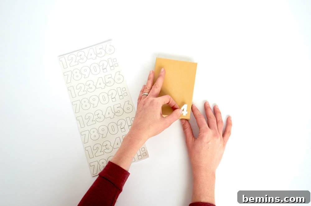Two hands folding yellow paper