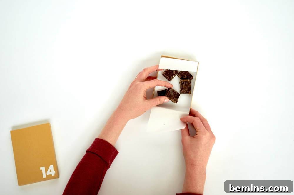 A hand crafting a piece of paper into something