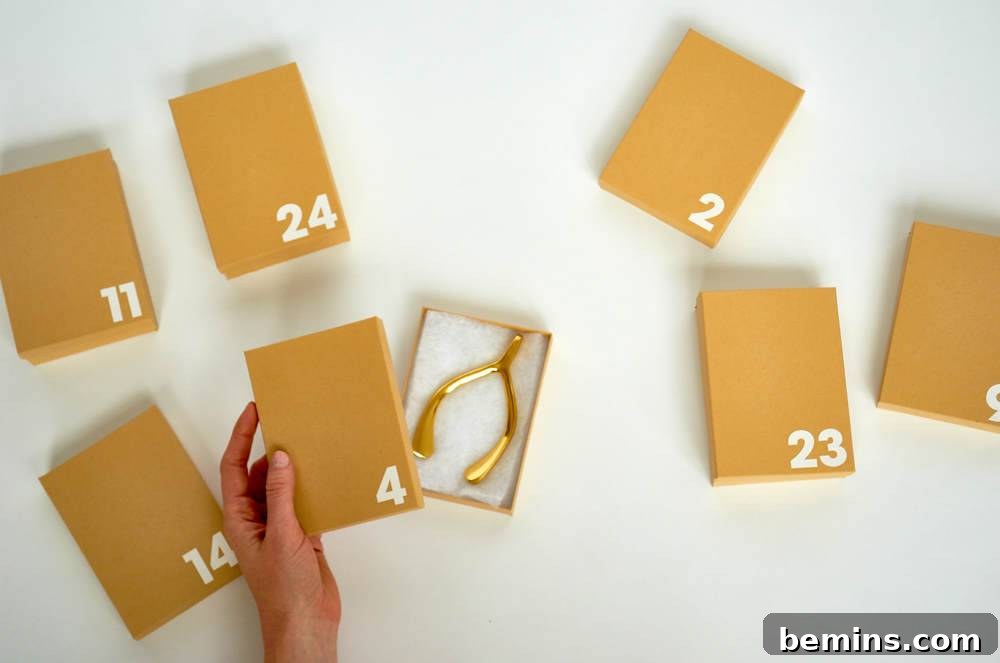A hand holds a small brown box with the number 4 on it and many other numbered boxes next to it.