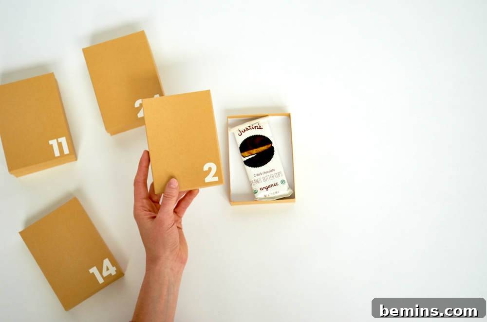 Four bown pieces of paper with numbers on them with a hand holding up one of them