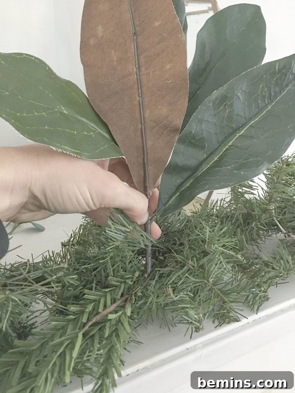 Adding magnolia leaves