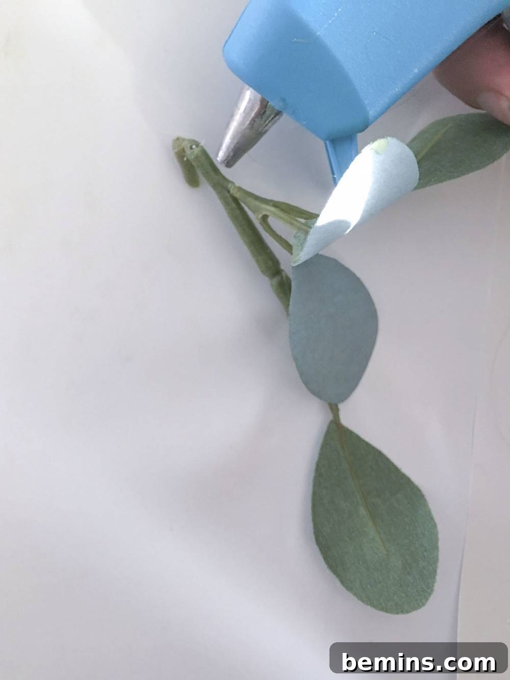 Adding hot glue to eucalyptus