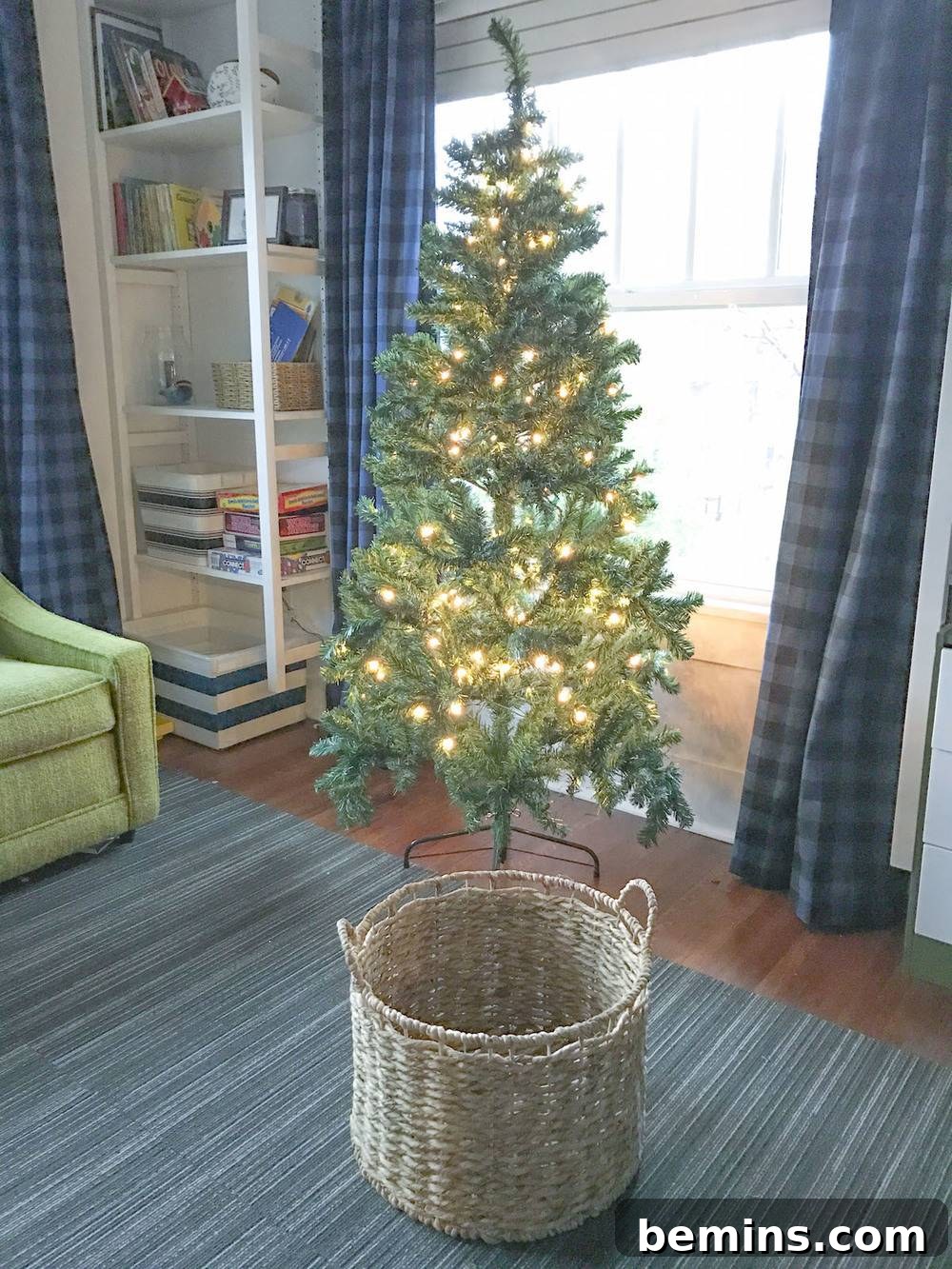 Christmas tree with wicker basket in foreground.
