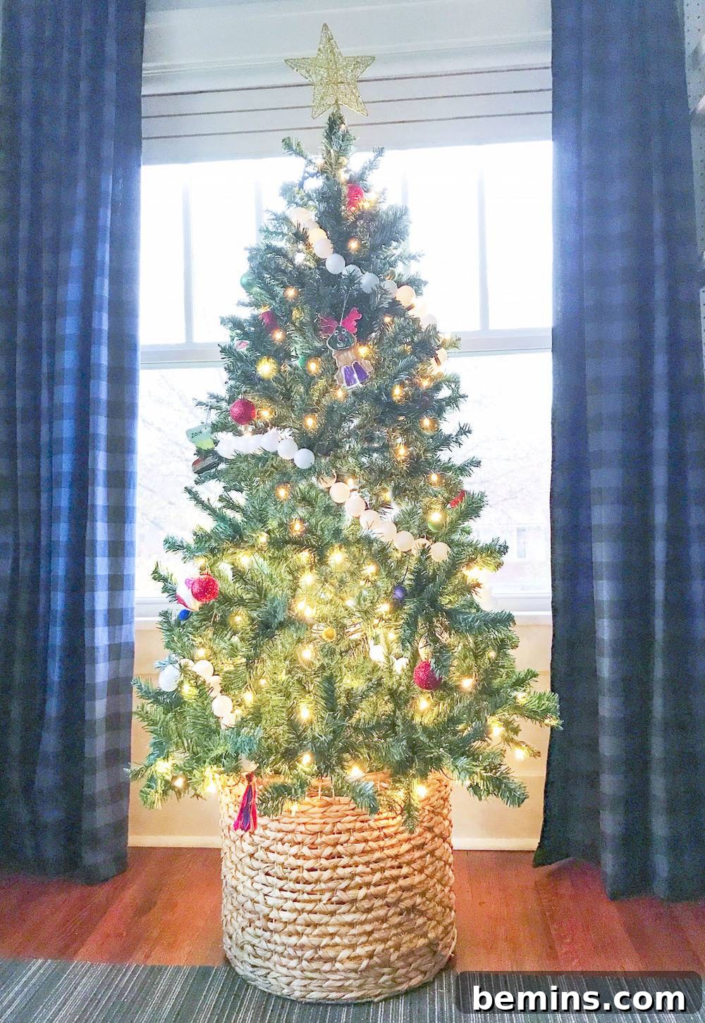 Artificial Christmas tree with wicker basket base.