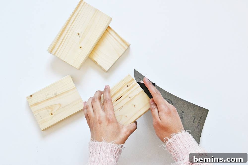 Sanding rough edges of cut wood for bookends