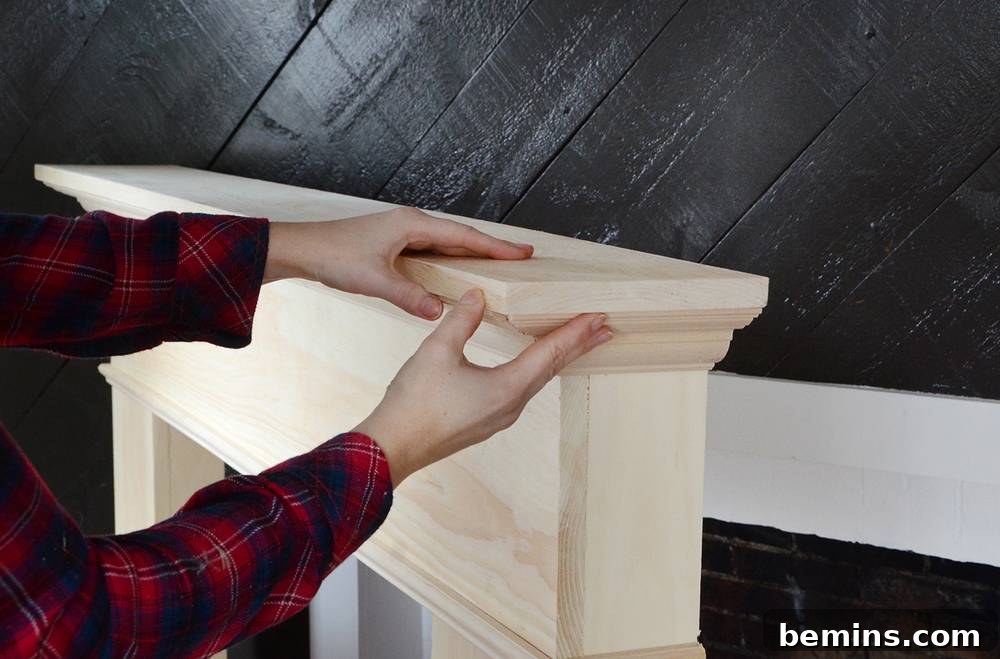Crafting Your Own Fireplace Mantel 13 Attaching the top surface to the DIY wooden mantel with wood glue