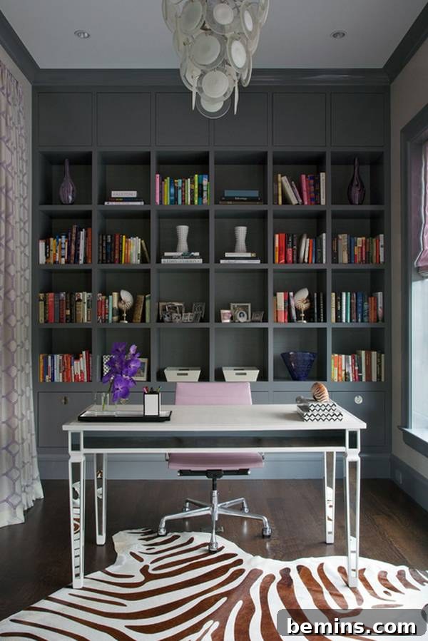 30 Impeccably Organized Studios for Creative Genius 12 Home office with moody dark built-in shelves and organized books and decor.