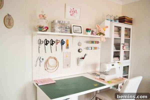 30 Impeccably Organized Studios for Creative Genius 17 Organized sewing space with pegboard and a storage cabinet.