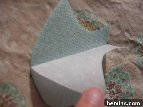 Peel off the remaining paper backing from the fusible web.