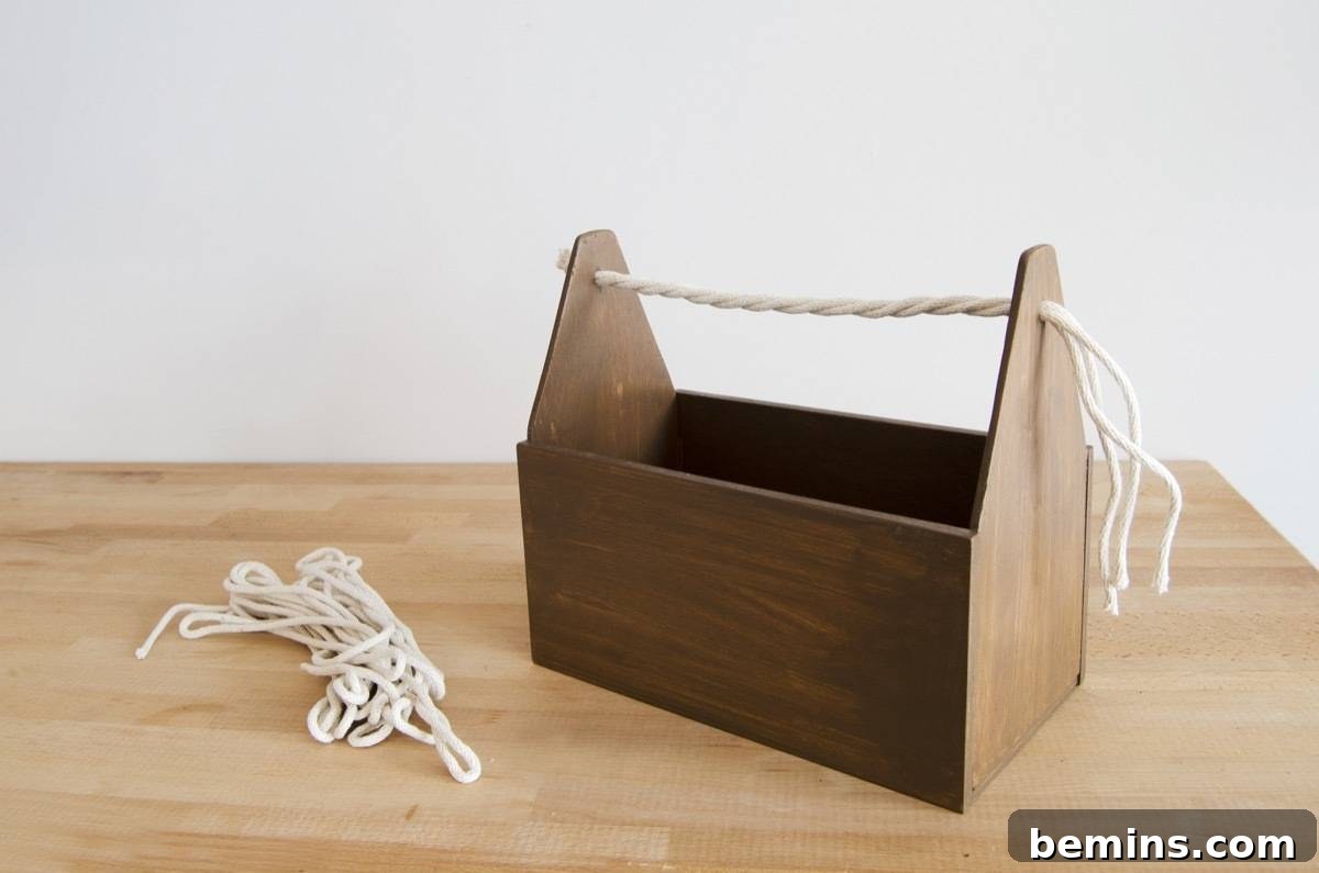 DIY Cleaning Caddy to Conquer Household Chores 8 DIY Wood Cleaning Caddy: Stain, and thread with rope for a natural-looking handle.