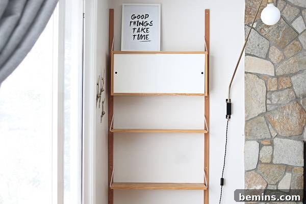 A framed print leaned against the wall adds a graphic touch to the shelf.