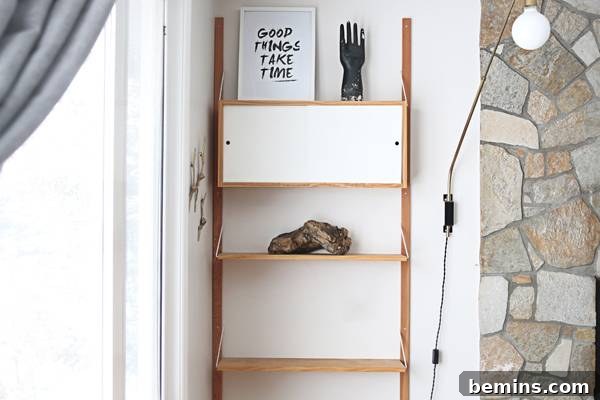 A large piece of driftwood adds a natural element to the shelf.