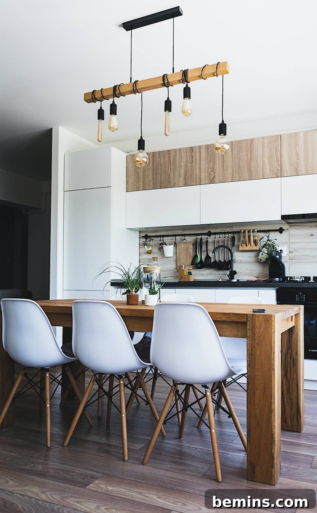 Dining table with white chairs near kitchen