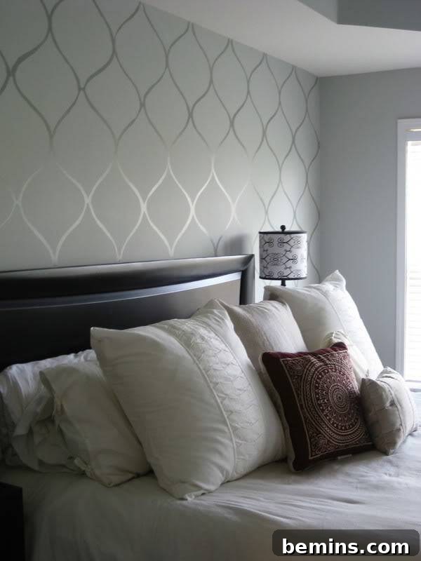 A stenciled wall adds a touch of elegance and sophistication to a bedroom.