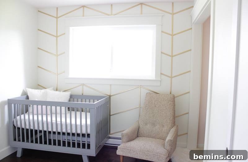 A herringbone accent wall adds a touch of classic style to a nursery.