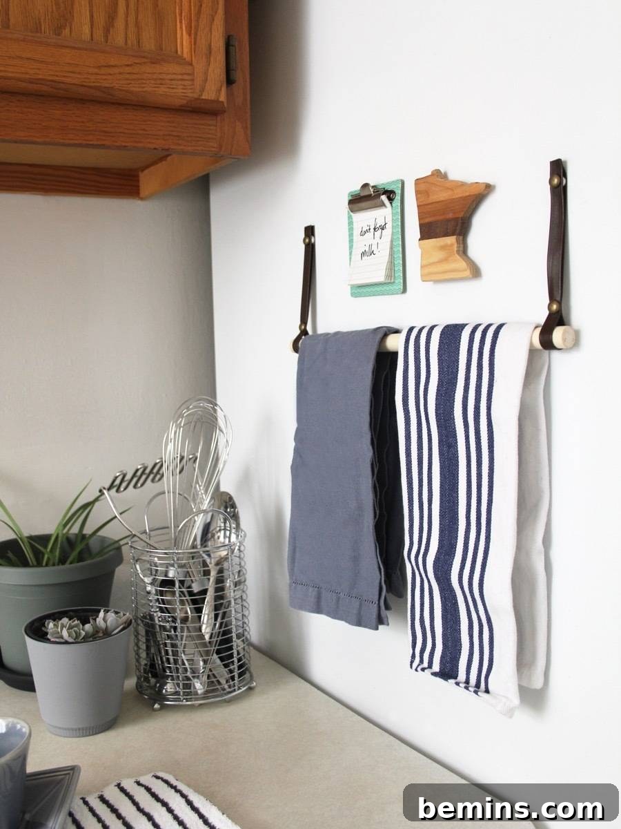Save storage space and go vertical! Use the side of the fridge to store towels with this DIY towel bar.