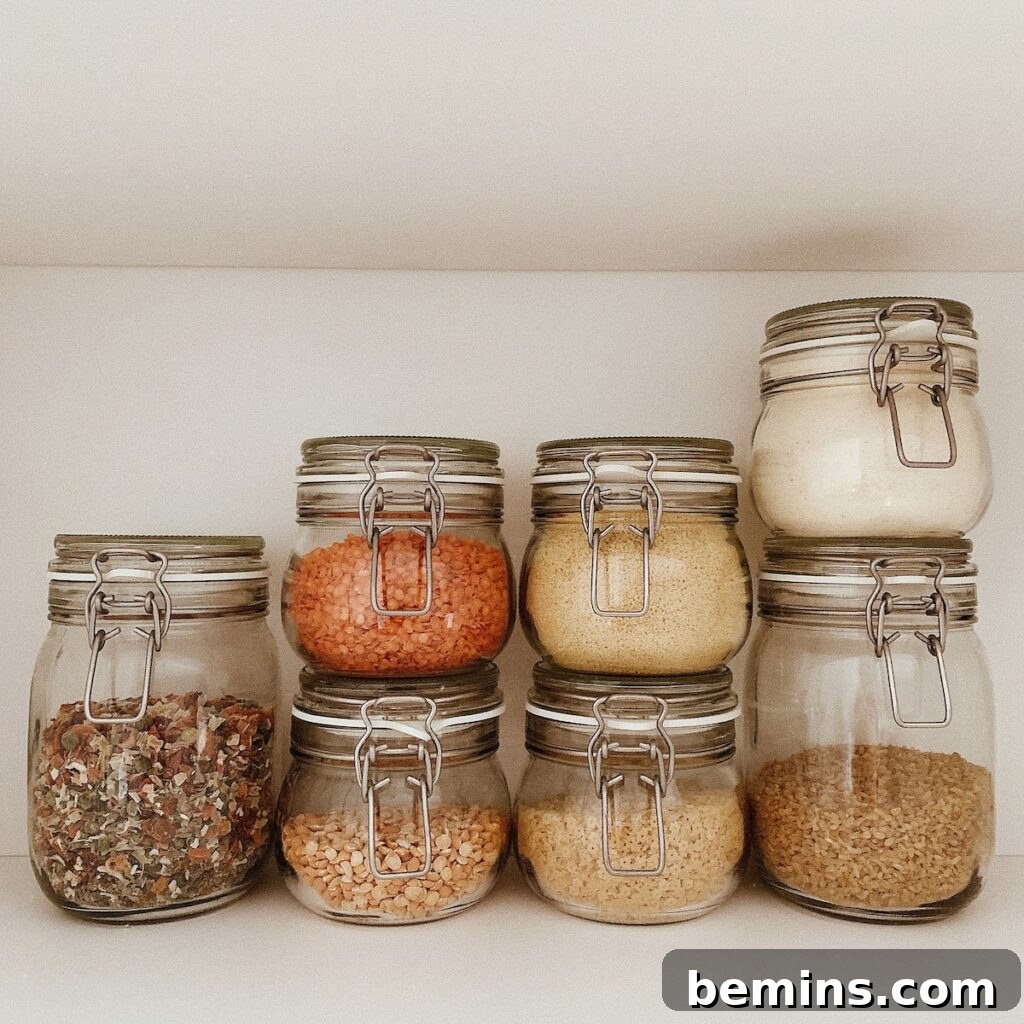 three clear glass jars with brown and white stones