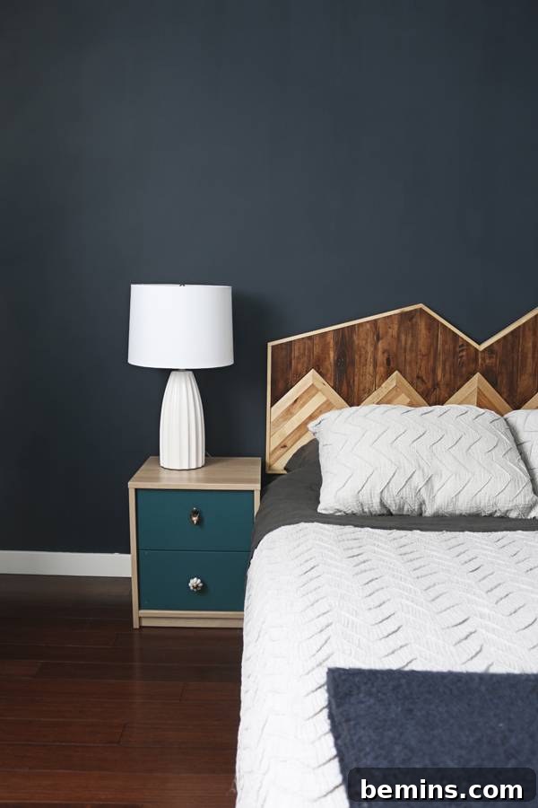 The master bedroom's accent wall with a unique mountain-shaped headboard, a focal point of the room's design.
