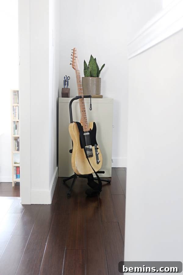Cambria's minimalist home office setup with a handmade desk, an All Modern chair, and a simple desk lamp, fostering a productive environment.