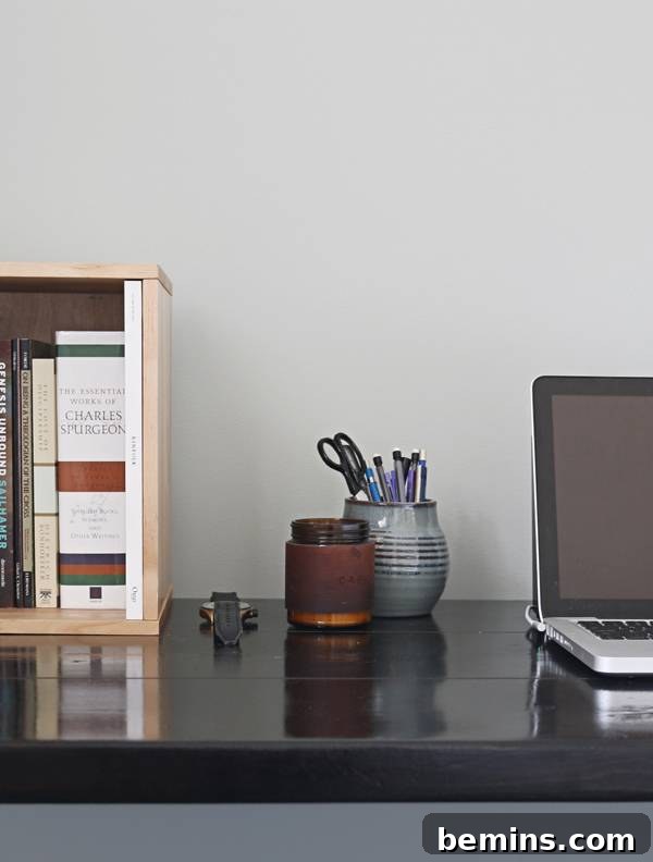 Close-up of Trenton's minimalist desk with musical equipment neatly organized and hidden storage solutions.