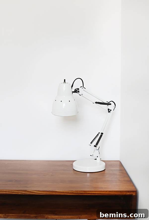 A focus on the simple and functional desk lamps from Walmart, providing essential task lighting in the minimalist office.