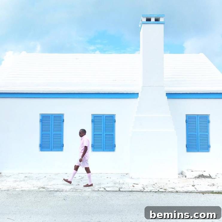 Beach-living inspired home exterior with pastel colors and palm trees, shared by Princess Bermuda on Instagram
