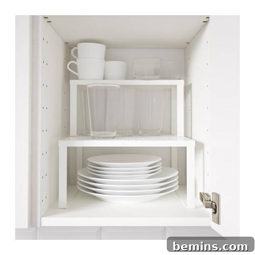 Cabinet risers used to organize plates in a kitchen cabinet