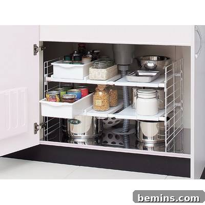 Under-sink multi-drawer organizer in a kitchen cabinet