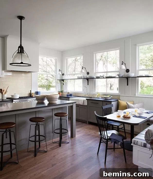 Farmhouse Modern kitchen with white table, black chairs, and pendant light.