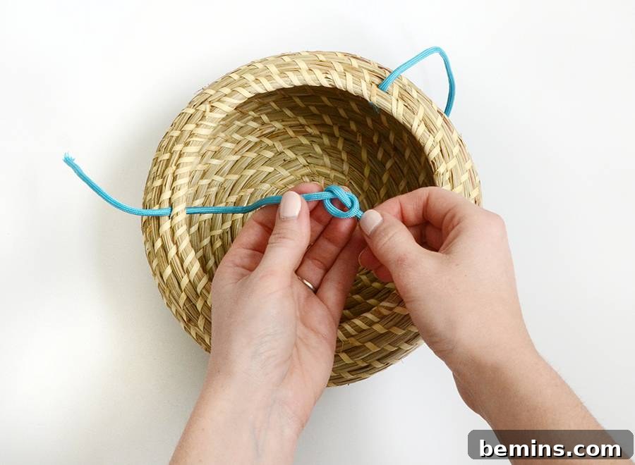 Tying a knot to secure the cord inside the basket