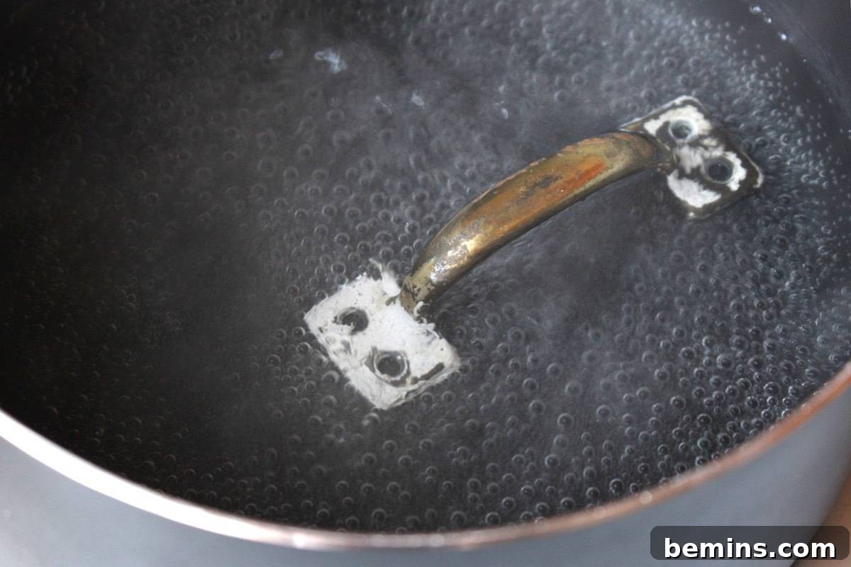 Restore painted door handles by heating them in water to remove old paint