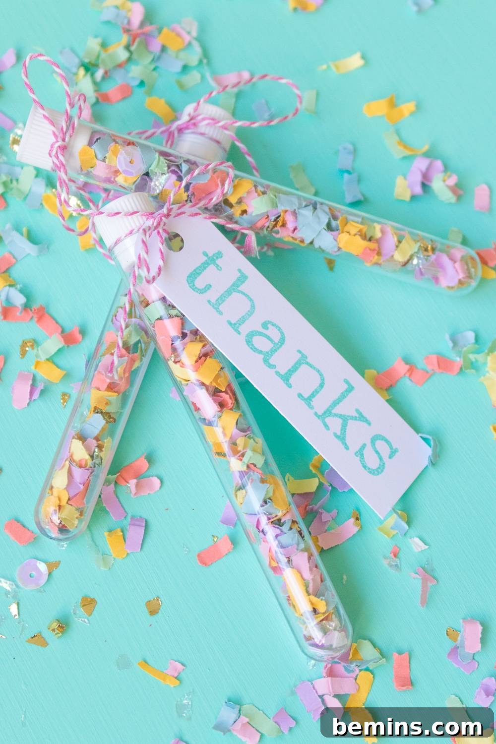 Adding ribbon to the confetti wedding favors.