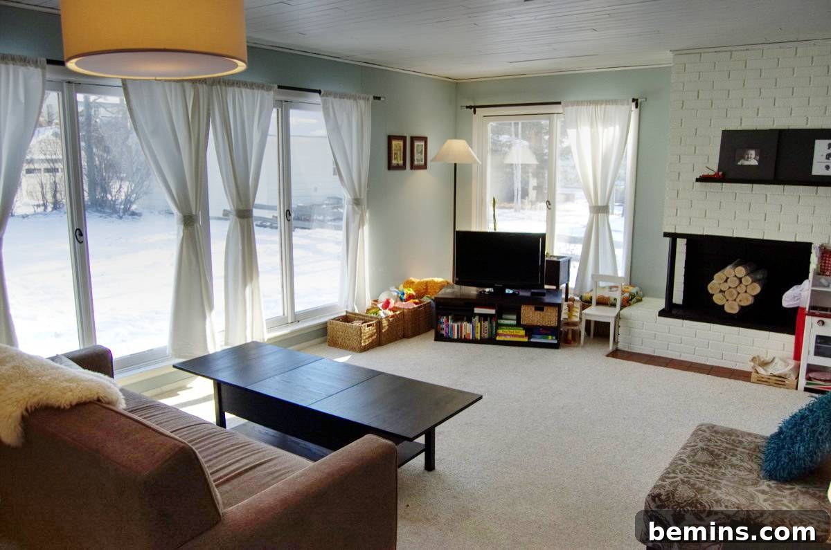 Living room with brown furniture and a television in the corner.