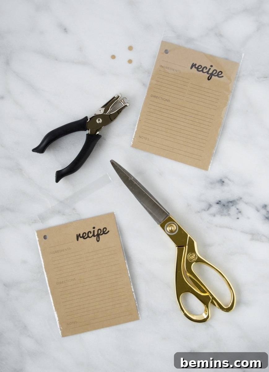Craft a Personalized Recipe Organizer 6 Punching holes and trimming excess vinyl for the recipe card booklet