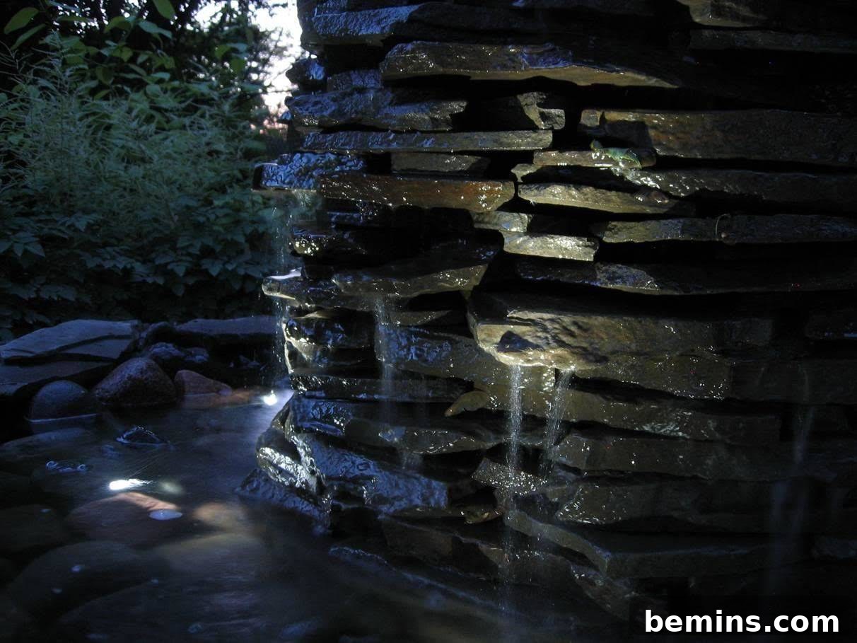 Creating a Backyard Oasis: A DIY Pond and Fountain Project 16 The waterfall pond illuminated at night, creating a magical and inviting atmosphere.