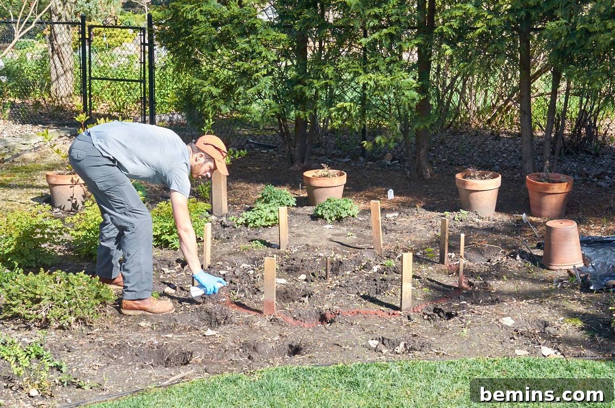 Creating a Backyard Oasis: A DIY Pond and Fountain Project 4 A man wearing an orange hat examines the marked outline of the future pond in a garden.