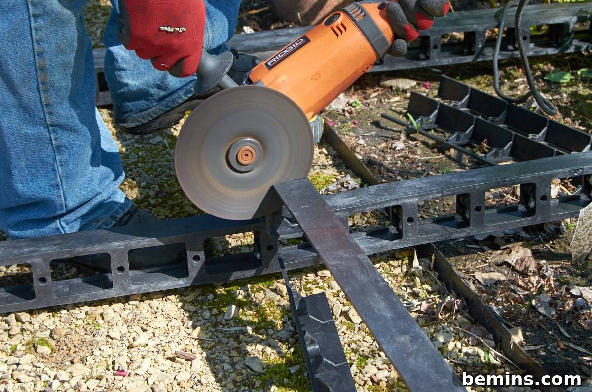 A person using a saw to cut materials for the fountain platform.