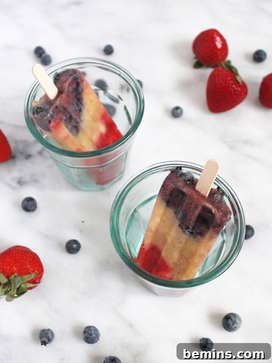 Patriotic Pops: Festive Frozen Treats for Everyone 8 Close-up of champagne popsicles with blueberries, strawberries, and bananas