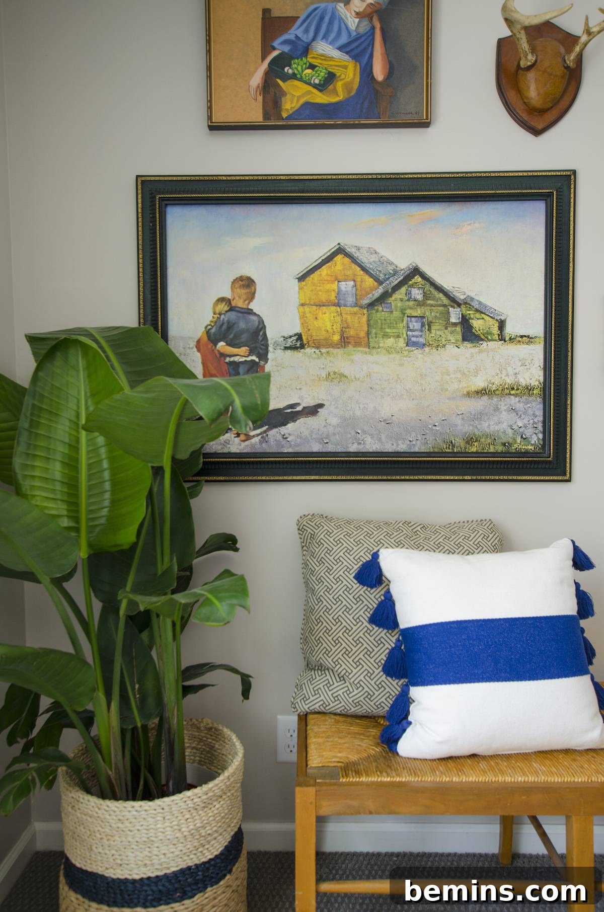 The completed eclectic gallery wall with furniture and accessories.