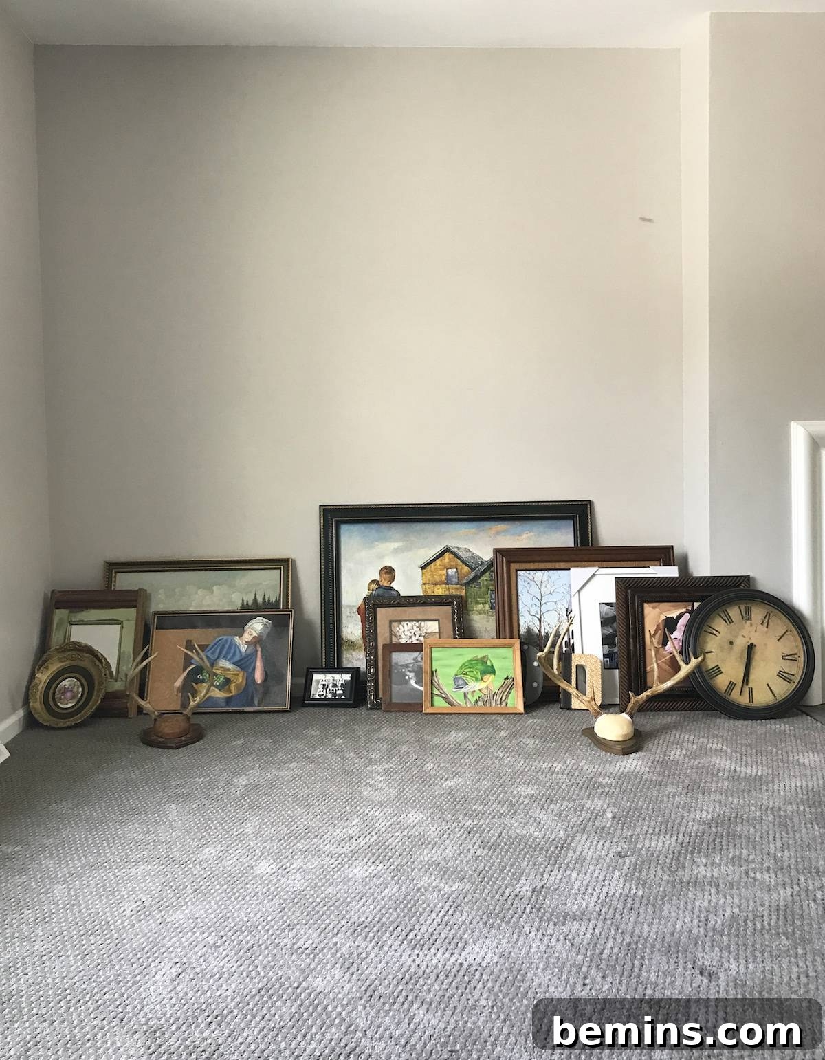 Collection of art and collectibles laid out for a gallery wall.