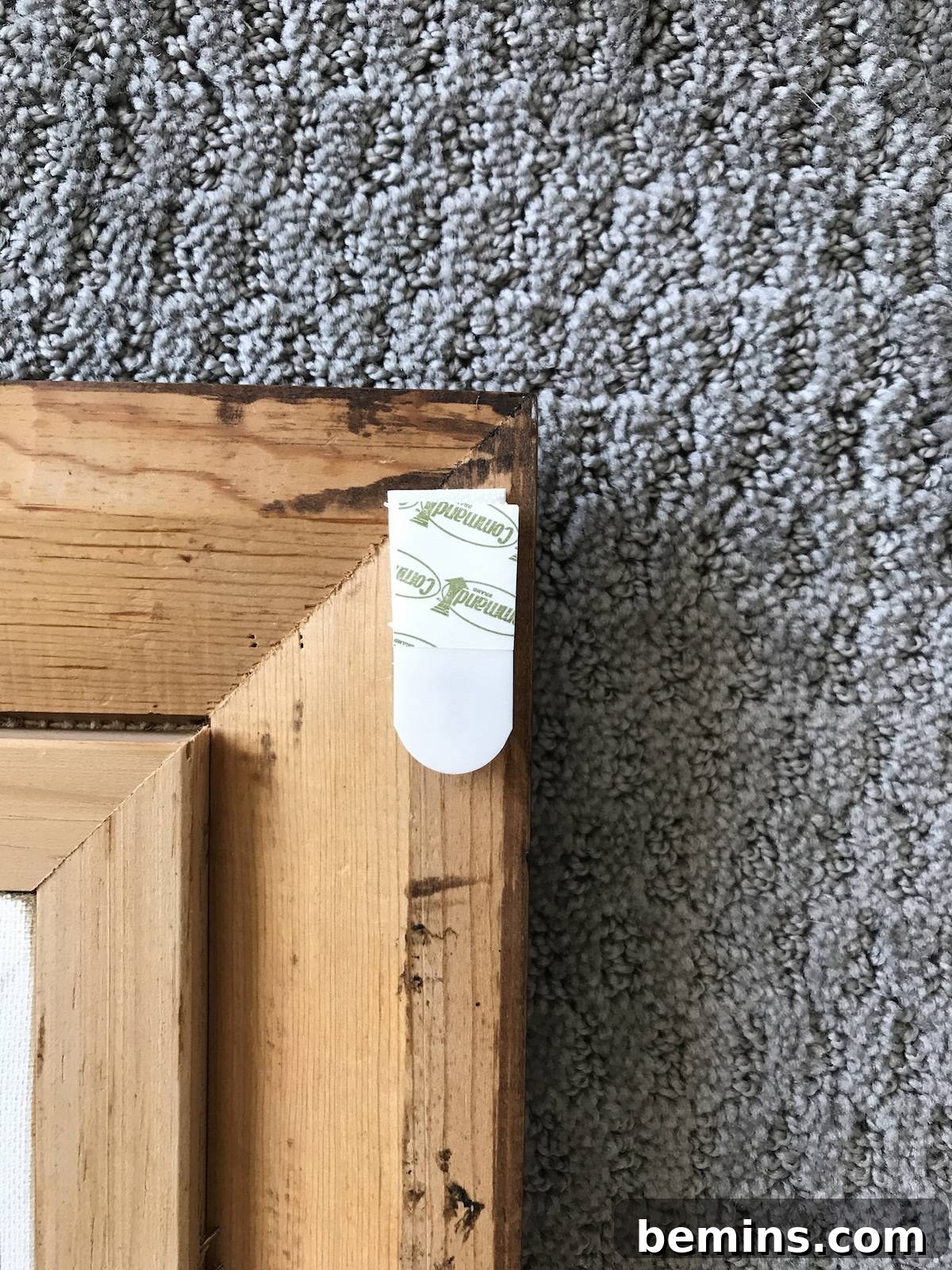 Hanging art on the wall using Command Strips.