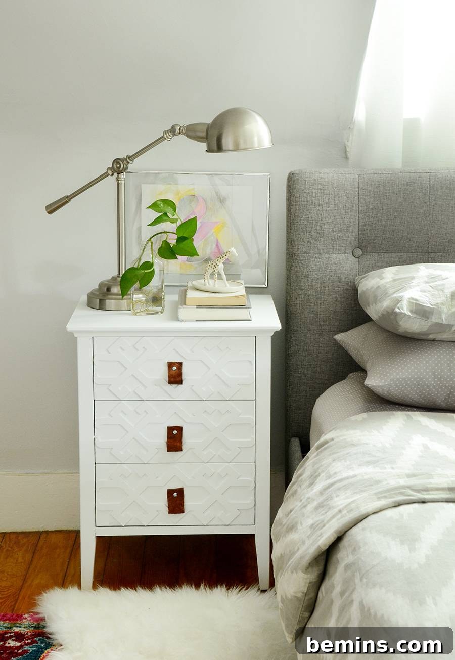 Nightstand after makeover with white chalk paint and leather pulls