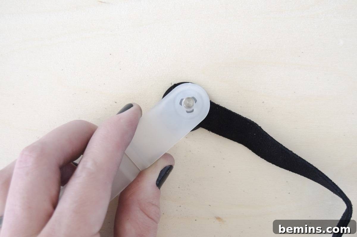 DIY Picnic Backpack - Step 3b: Hammering the awl to create a hole