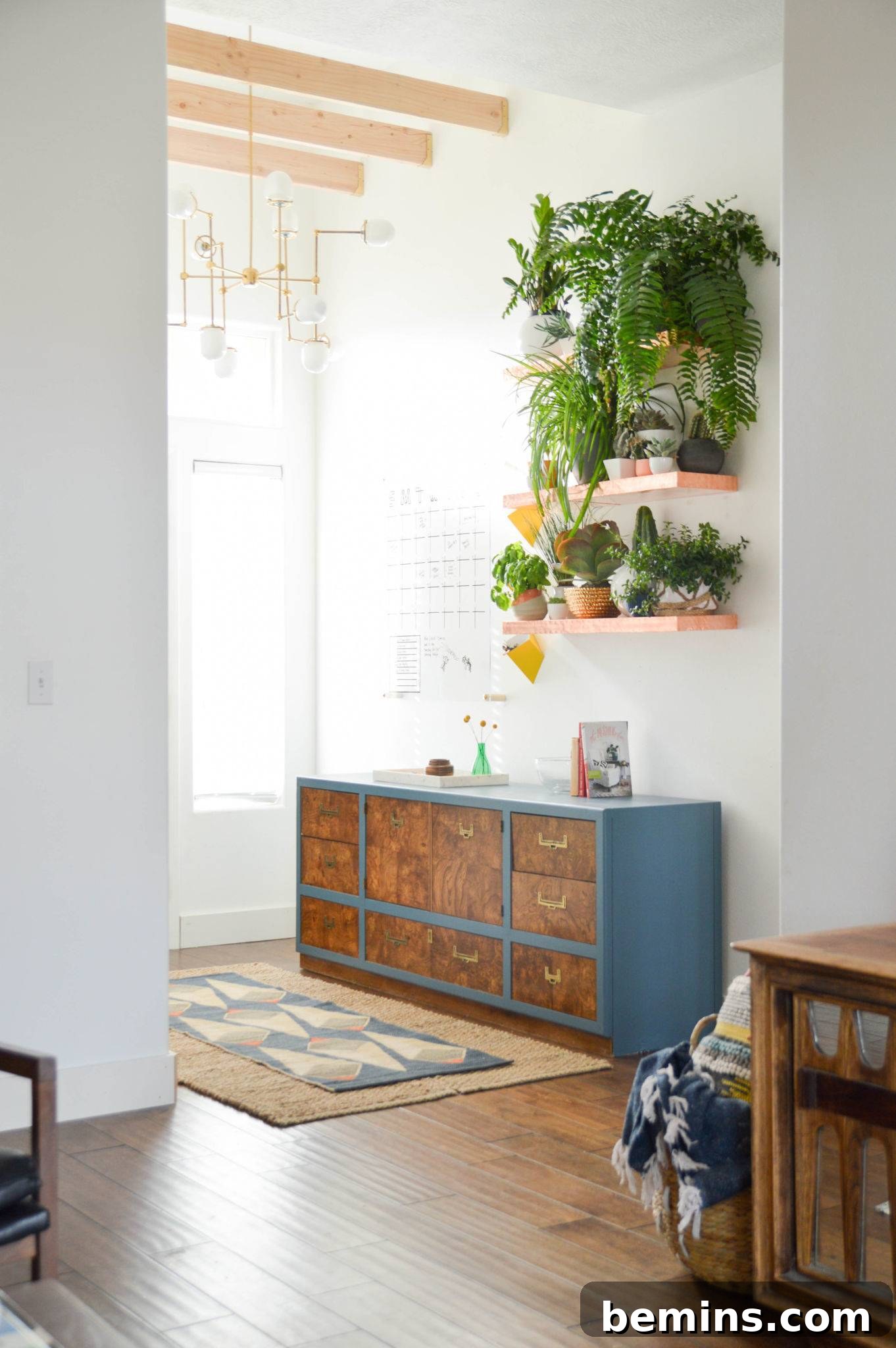 Living room with cream walls and a blue cupboard.