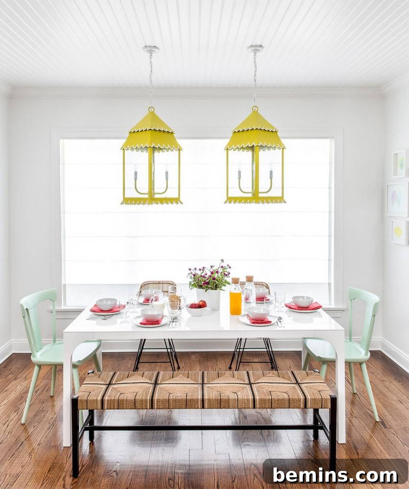 Dining area with white table and chairs under warm lighting.
