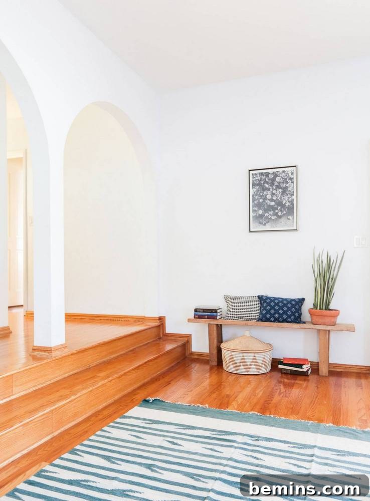 White room with a blue and white rug.