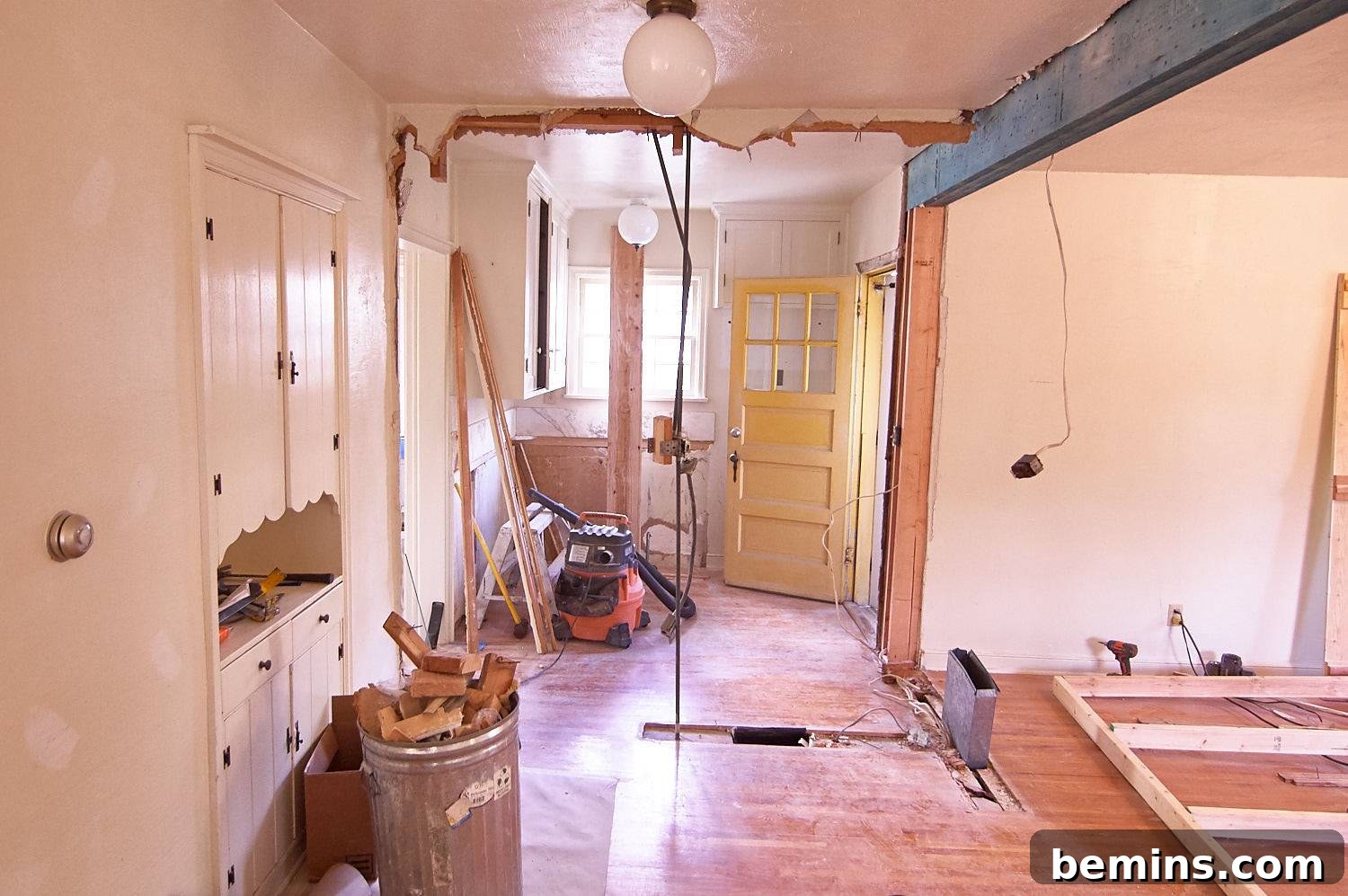 A room under construction with a full silver garbage can of wood pieces, depicting the demolition phase