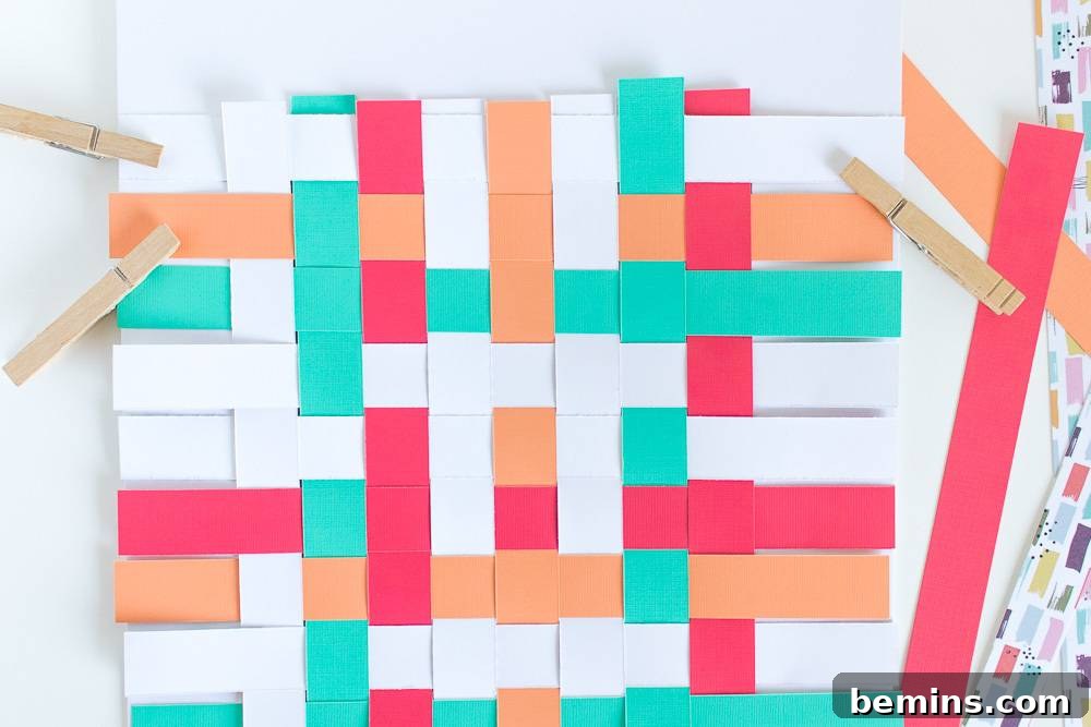Papers make a criss cross pattern held up by clothes pins.
