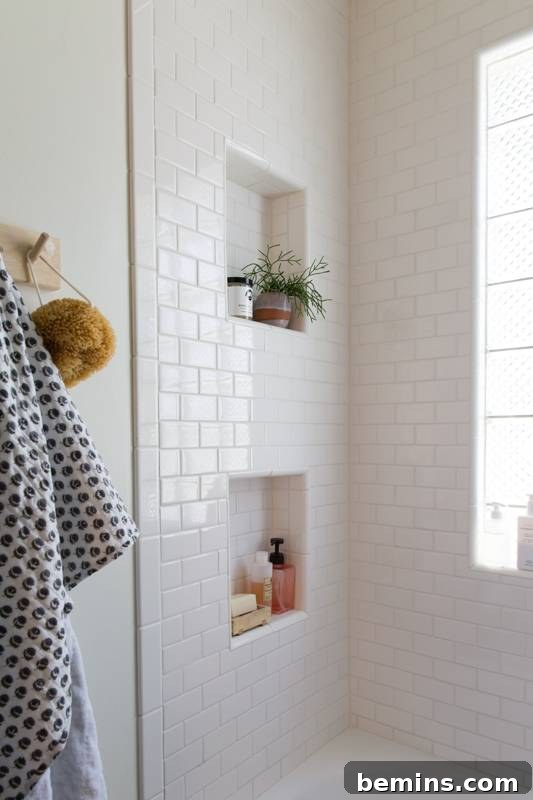 17 Stunning Bathrooms That Embrace the Shower Plant Trend 11 A shower with a plant on a shower shelf.