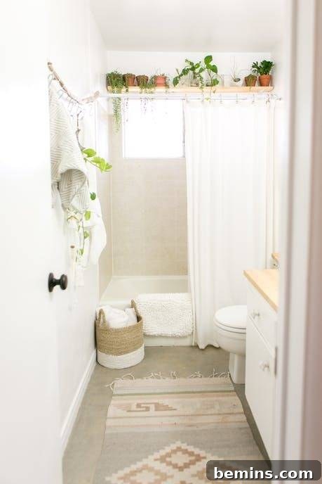 17 Stunning Bathrooms That Embrace the Shower Plant Trend 12 A white bathroom has plants lined across the ceiling.
